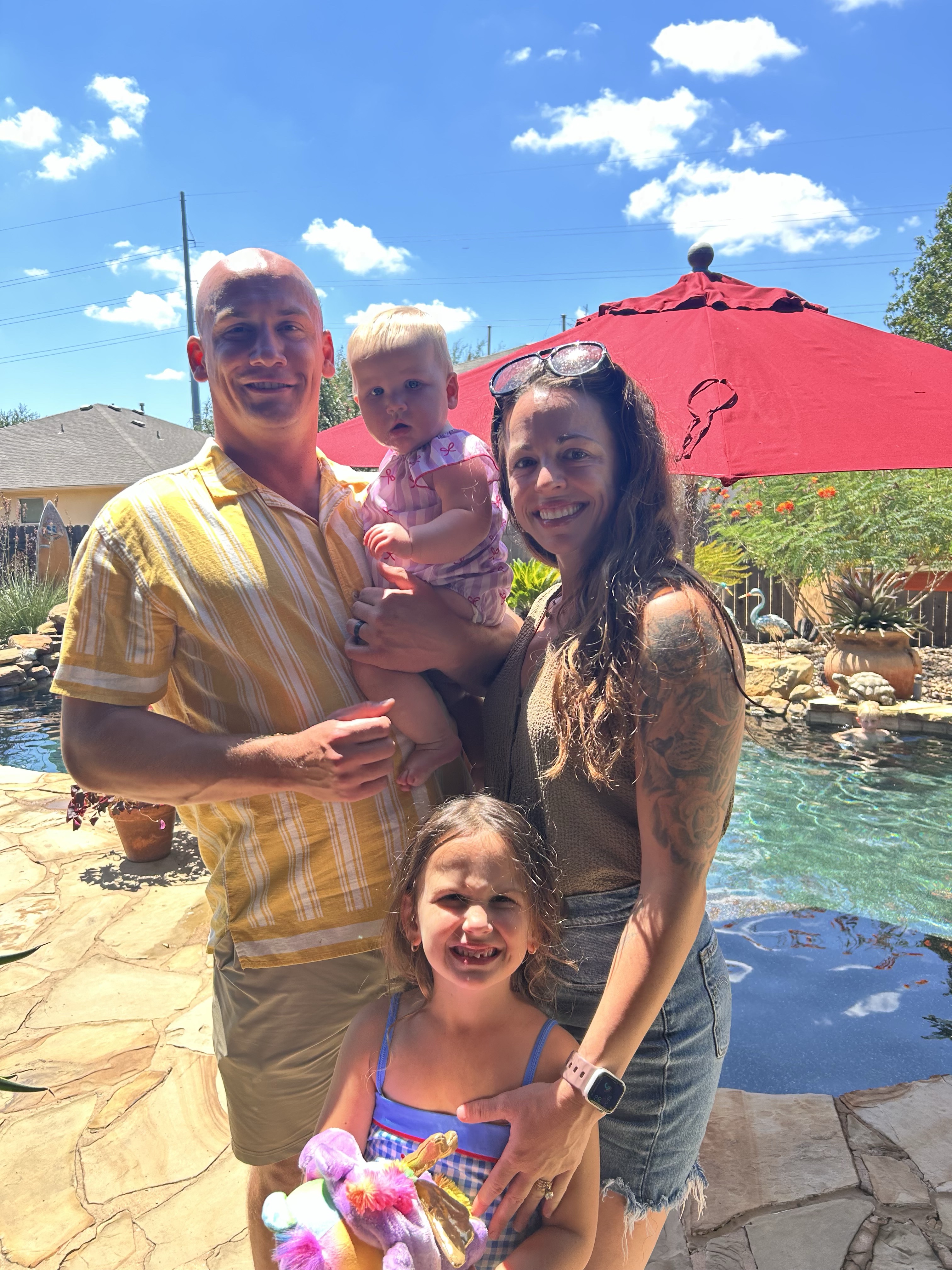 Dalton Dellsperger with his wife and two daughters in their Liberty Hill backyard